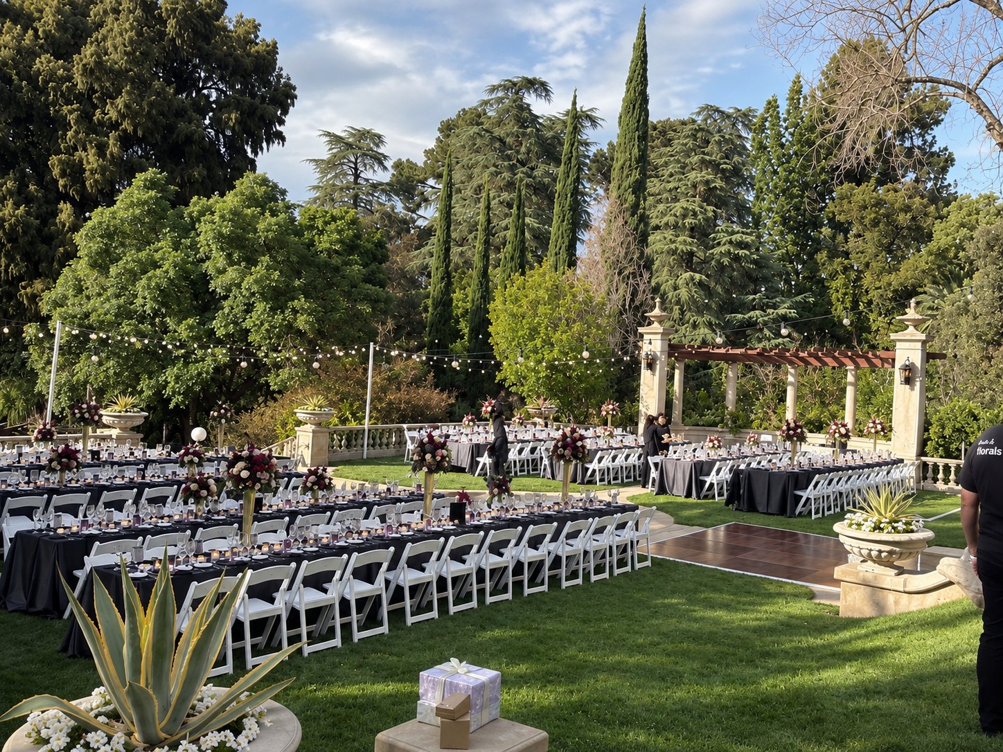Garden gala with long dining tables and string lights